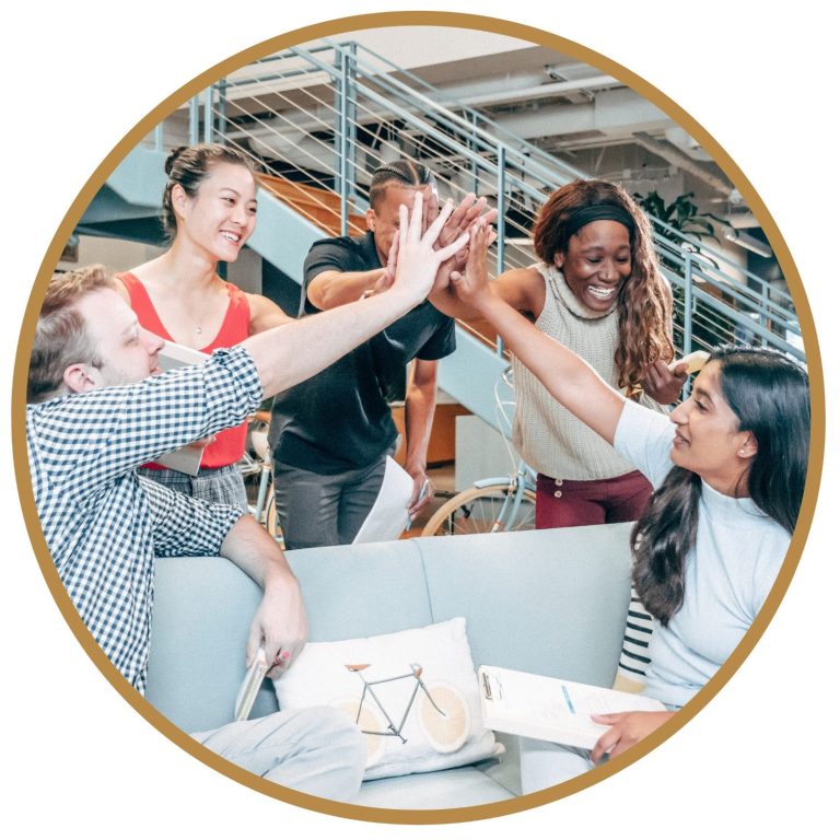 Un groupe diverse de personnes échange des encouragements dans un cadre professionnel et collaboratif.
